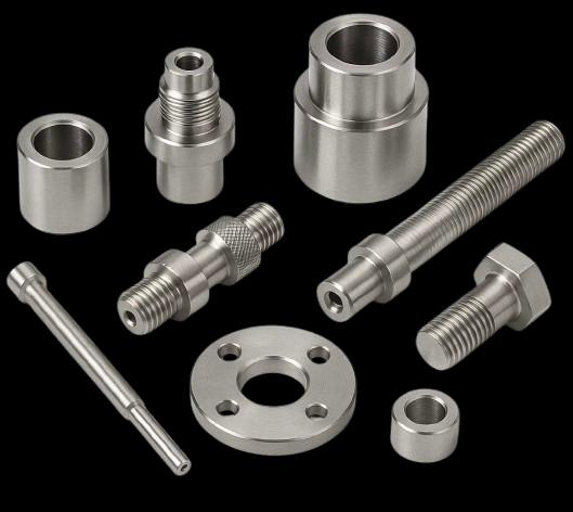 Assorted precision CNC machined components — bushes, spacers, threaded studs, bolts and flanges